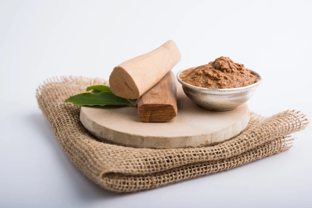 ayurvedic-chandan-sandalwood-paste-silver-bowl-with-sticksand-leaves-placed-sahanor-sahana-circular-stone-base-creating-paste